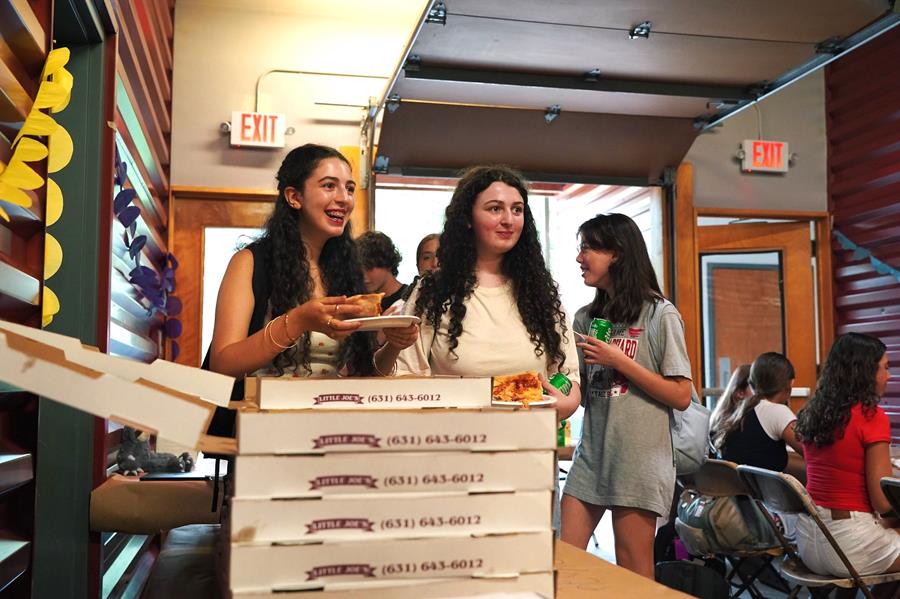 Students who have been coming to Usdan for five of more years celebrated their milestone over pizza backstage on Tuesday.