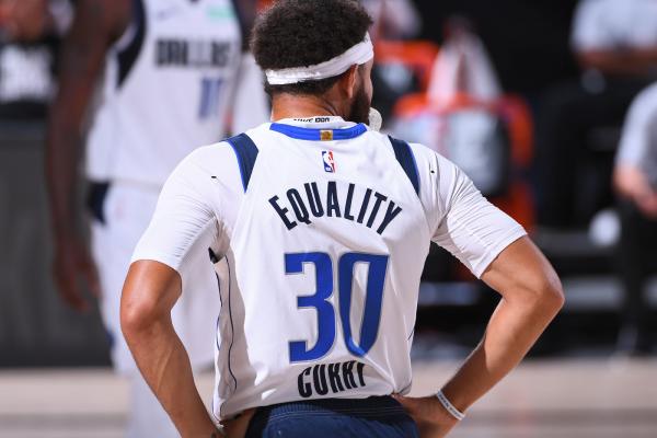 Basketball player with the words "Equality" written on the back of his jersey