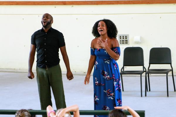 two adults singing