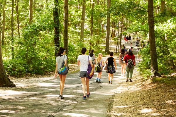 students walk on a path at Usdan