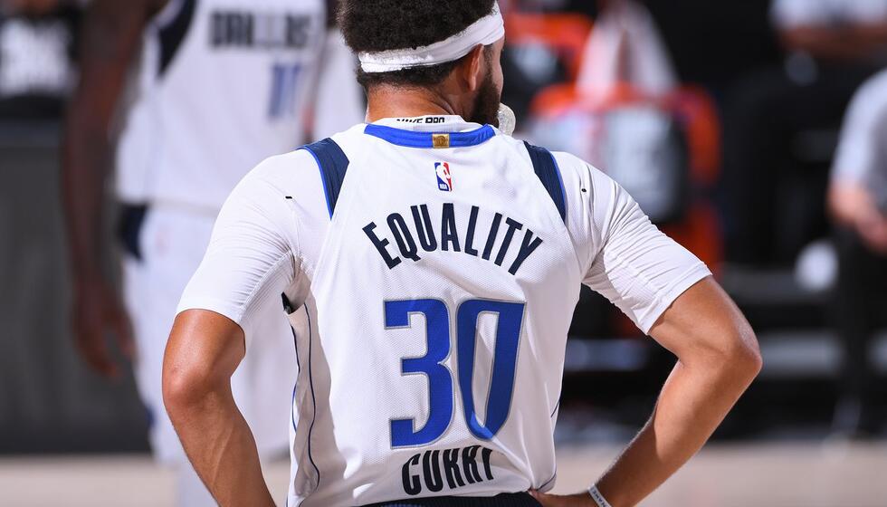 Basketball player with the words "Equality" written on the back of his jersey.