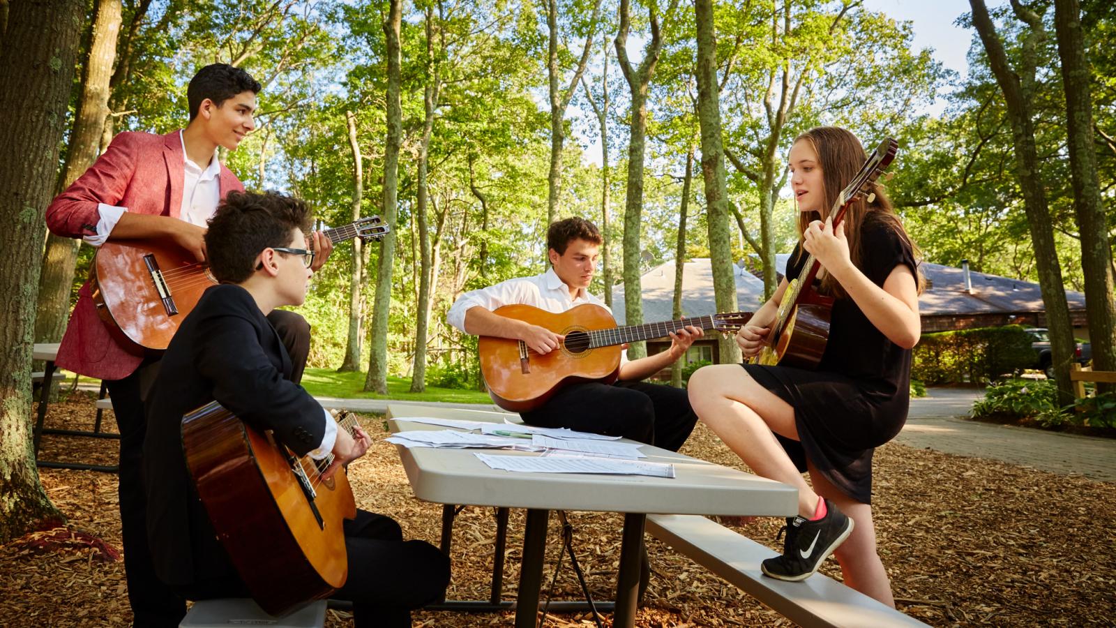 four playing guitar