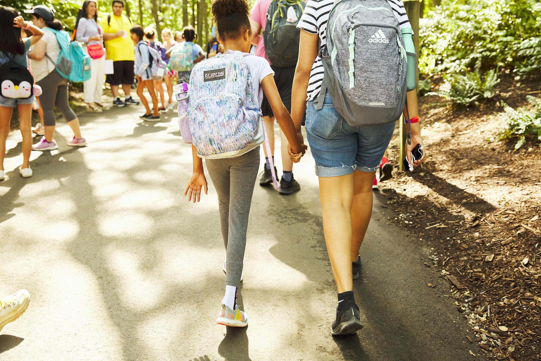 Students walking hand-in-hand 