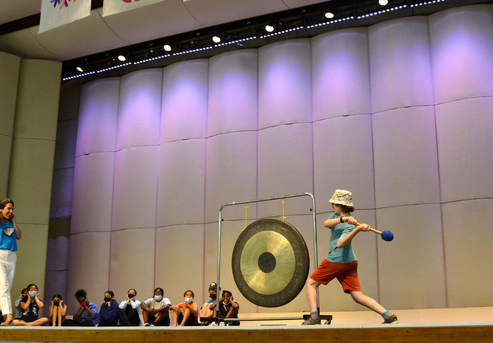 Student ringing gong