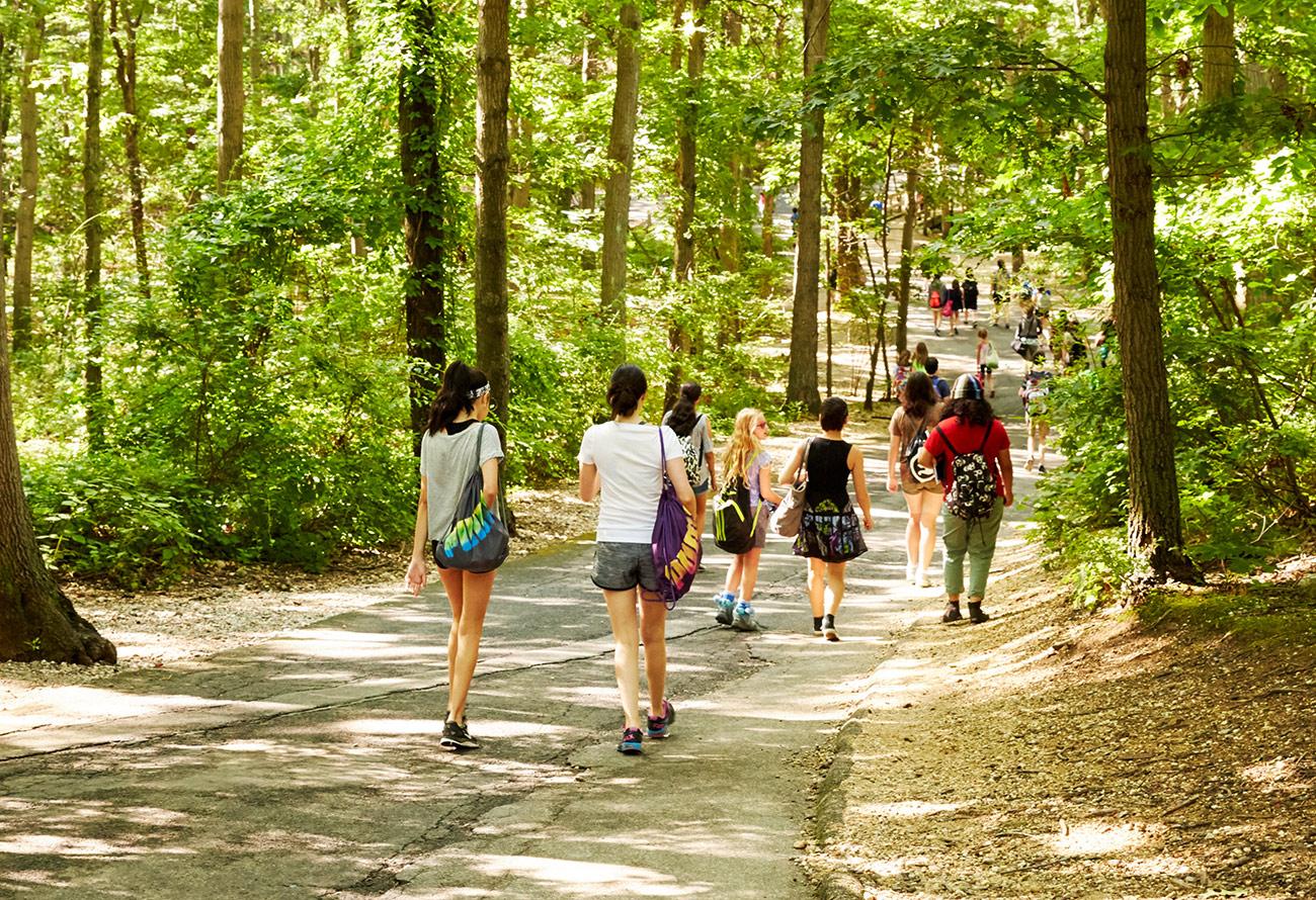 students walk on a path at Usdan
