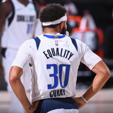 Basketball player with the words "Equality" written on the back of his jersey.