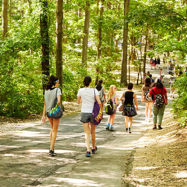 students walk on a path at Usdan